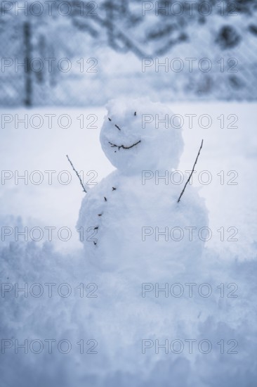 A small snowman stands alone in the snow, surrounded by winter silence, Waldachtal, Freudenstadt