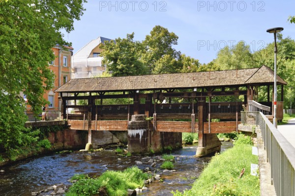 Ettlingen, Germany - August 13th 2025: Old wooden bridge over the Alb river. Historic landmark on a