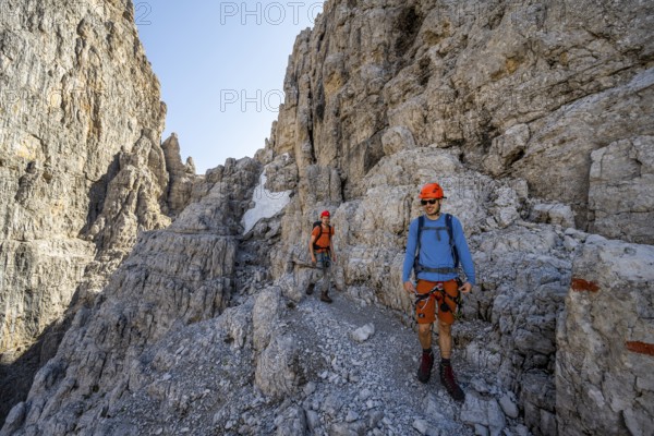 Two mountaineers on the Via Ferrata Bocciere Centrale via ferrata, spectacular mountain landscape