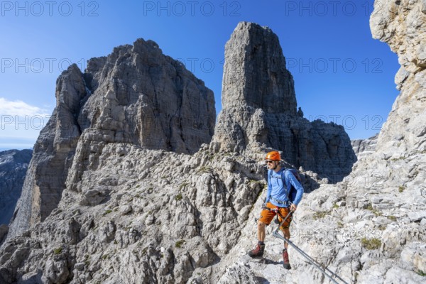 Climbers on the Via Ferrata Bocciere Centrale via ferrata, spectacular mountain landscape with