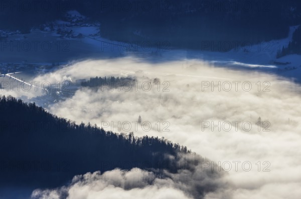 View of a sea of fog from Vormauerstein, Strobl am Wolfgangsee, church tower sticking out of the
