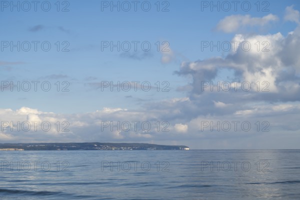 View across the Baltic Sea towards the chalk coast, sky with white clouds, Binz, seaside resort,