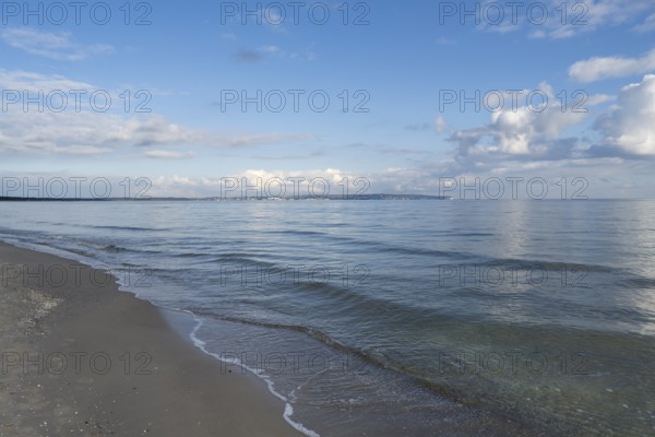 View across the Baltic Sea towards chalk coast, beach, sky with white clouds, Binz, seaside resort,
