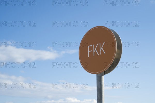 Naturist sign against blue sky with white clouds, Binz, seaside resort, Rügen island, Baltic Sea,