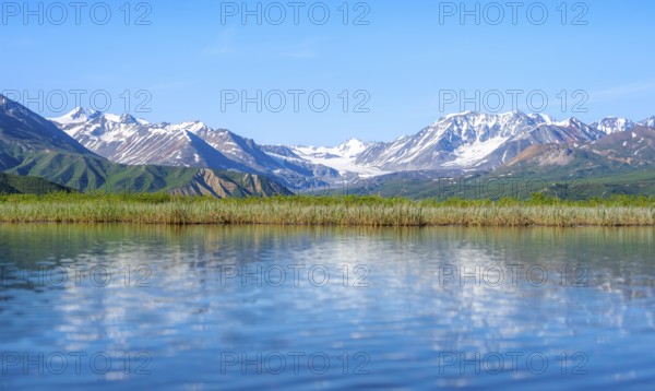 Lake and picturesque mountain landscape with Gulkana glacier and summit Icefall Peak, Richardson