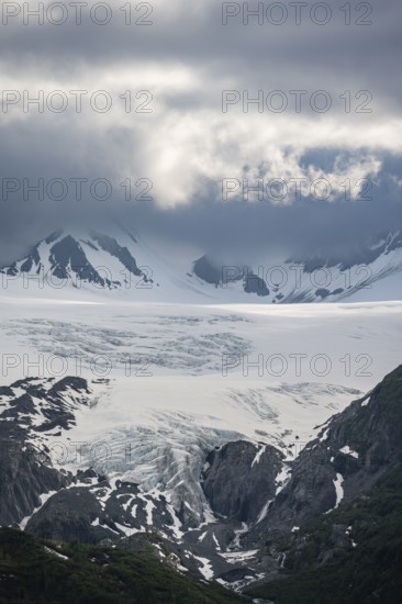 Mountain peak with Worthington Glacier glacier, dramatic cloudy sky, picturesque landscape on