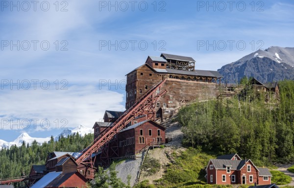 Red Kennicott buildings in front of mountainous landscape, Kennicott Concentration Mill to extract