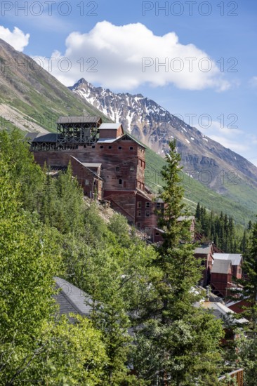 Red Kennicott buildings in front of mountainous landscape, Kennicott Concentration Mill to extract