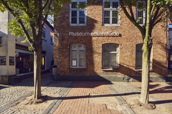 Eckernförde Museum, pedestrian zone, brick building, façade with windows, paving and paving stones,