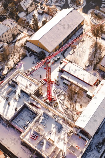 Detailed aerial view of a construction site in a snowy urban landscape, Zellerschule building,