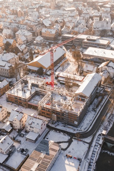 Close view of a snowy construction site in the middle of an urban residential area, Zellerschule
