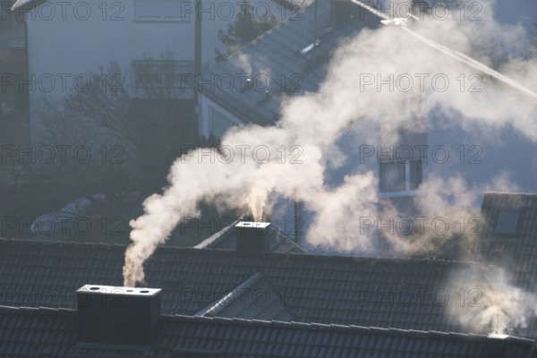 Close-up of a chimney from which smoke rises in a quiet morning mood, symbolic picture, fireplaces,