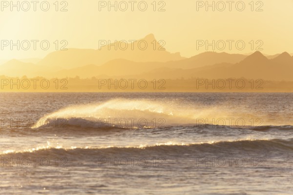 Evening light at Cape Byron with view to Mount Warning and sunlit hinterland, New South Wales,