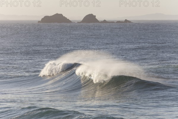 Looking towards Julian Rocks Nature Reserve across the breaking waves. Ocean view, Byron Bay, New