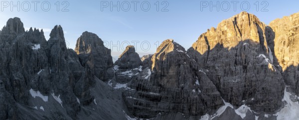 Aerial view, alpine panorama, Cima Tosa and rocky peaks at sunrise with alpine glow, picturesque