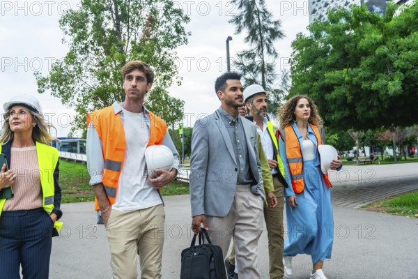 Group of diverse construction professionals and architects wearing hard hats and safety vests,