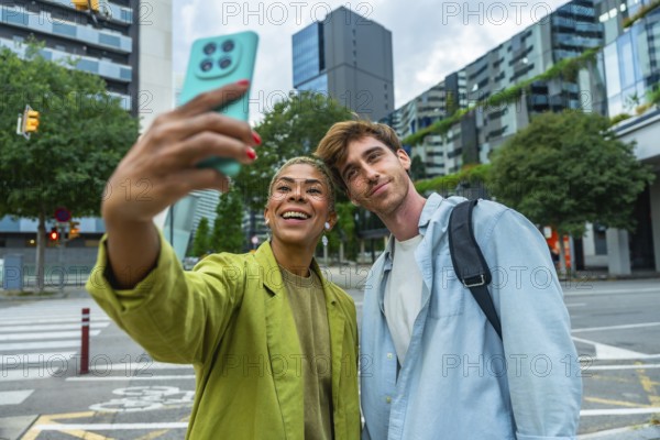 Smiling multiracial young adults enjoying a moment together outdoors, capturing a selfie with a