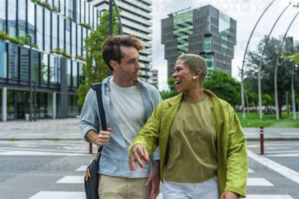 Engaging diverse colleagues walking across a city crosswalk, sharing a moment of laughter while