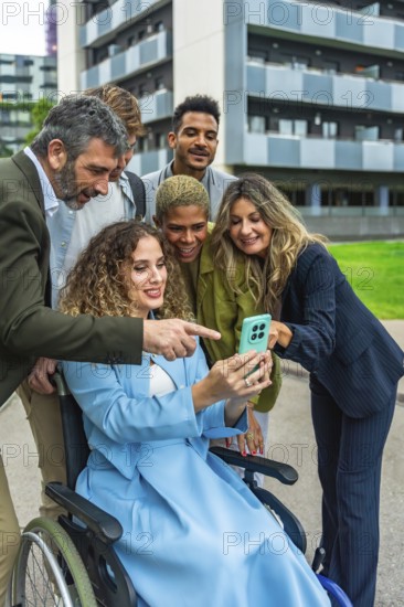 Multi ethnic business team smiling and reviewing a corporate project on a smartphone held by a