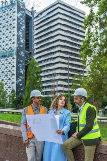 Diverse group of architects and construction professionals in hard hats and vests analyzing