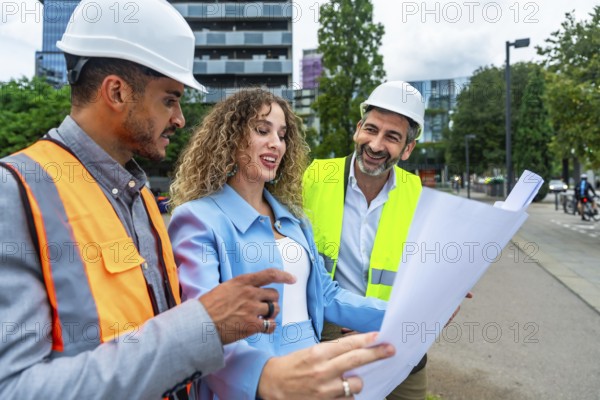 Diverse group of construction professionals discussing architecture plans and collaborating on a