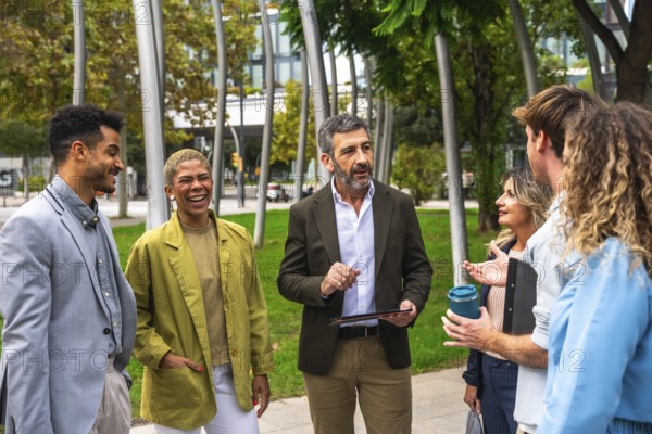 Diverse group of business professionals meeting, exchanging ideas, and smiling outdoors in a modern
