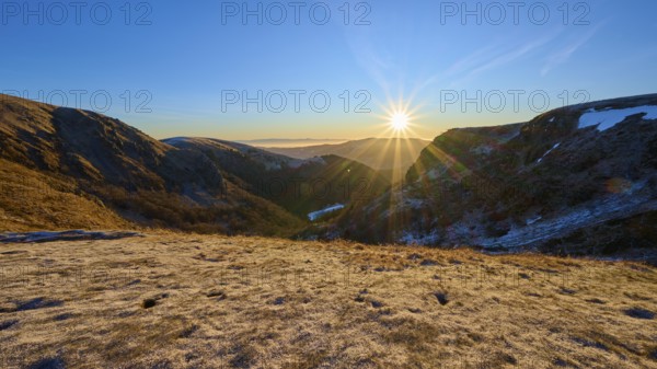 Frosty mountain landscape at sunrise with bright sunlight and clear sky, winter, Route de Cretes,