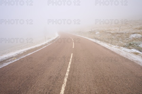 Gentle curve of a road in thick fog, winter, Route de Cretes, Hohneck, La Bresse, Vosges, France