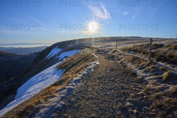 Snowy trail on a ridge at sunrise, clear view with frosty landscape, winter, Route de Cretes,