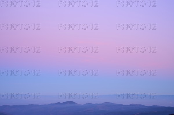 Mountain range under a calming sky in pastel shades of purple, pink and blue, looking at, Rhine