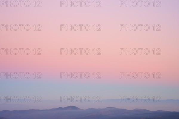 Mountains under a clear sunset sky in pastel shades of pink, purple and blue, viewing, Rhine