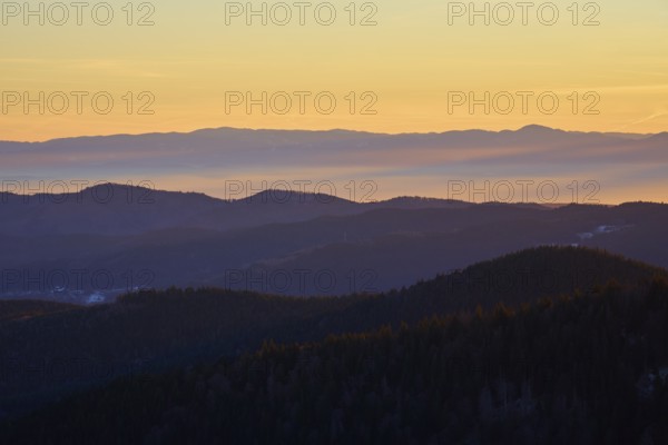 Mountains in silhouette at sunrise in warm shades of orange and yellow, view, Rhine Valley,