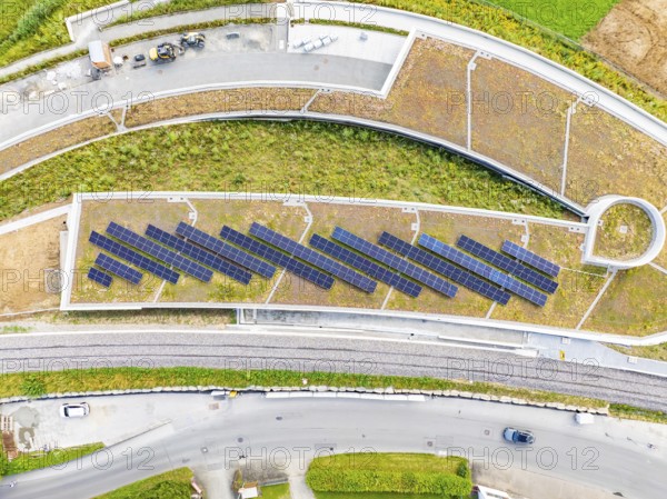 Solar panels on a flat roof surrounded by roads and vegetation, new park and ride car park Calw