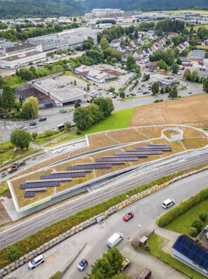 View of urban landscape with solar panels and road traffic, new park and ride car park Calw