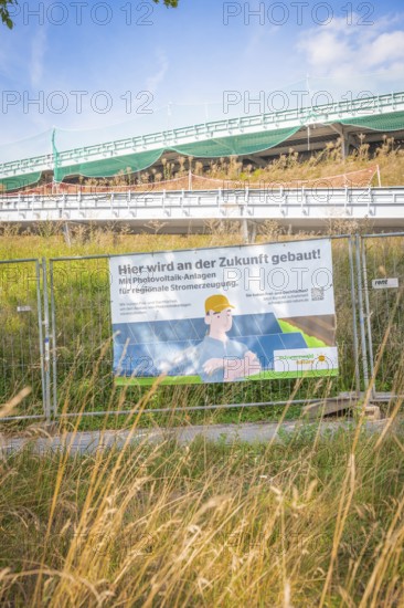 Construction site with advertising for photovoltaic systems for regional power generation under
