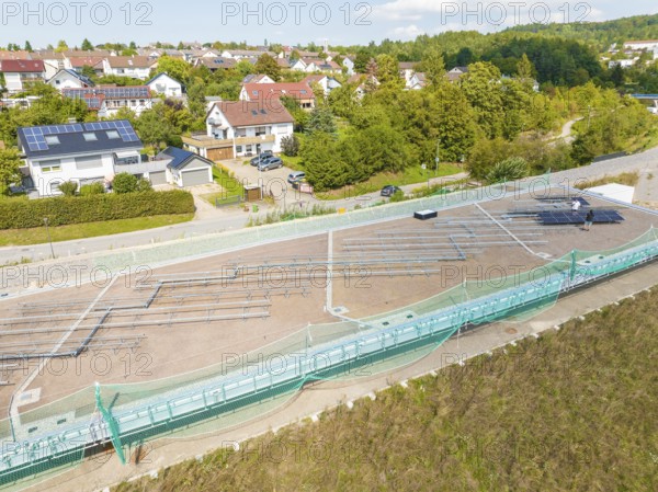 Construction site for solar systems in a quiet residential area with green areas and sun, new park