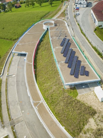 Round road layout next to solar panel system on a roof, new Park and Ride Calw Heumaden car park on