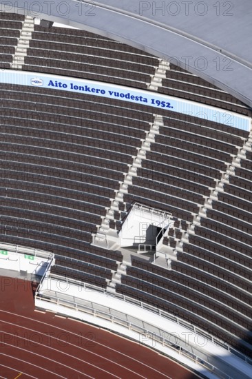 Modern stadium stand with empty seats, outdoor stairs and tartan track, Helsinki Olympic Stadium,