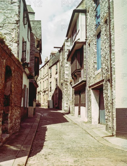 Historic buildings cobbled street including listed Elizabethan House with distinctive jettied,