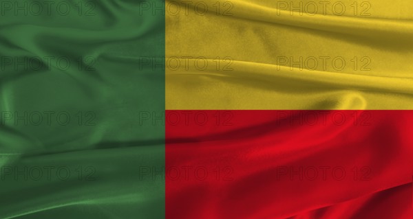 Flag of Benin with fabric textured background. Close up of National flag of Benin with realistic