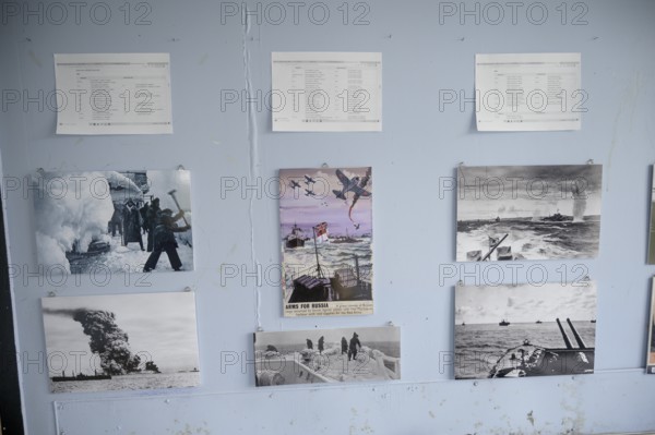 Wall with war pictures and documents in black and white in the partisan museum in the old school of