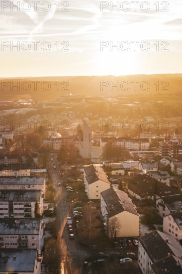 Aerial view of a city at sunset, warm colors, modern buildings and roads, Calw, Black Forest,