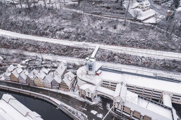 Snowy city view with bridge over a river and traditional architecture, Calw, Black Forest, Germany