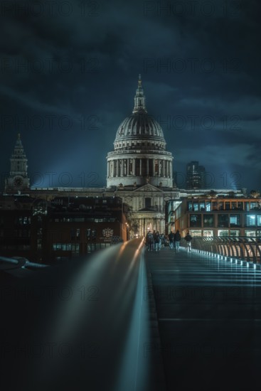 St Paul Cathedral with illuminated bridge in the foreground and urban night atmosphere, London,