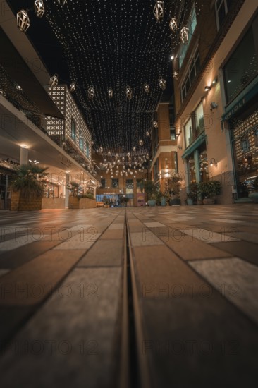 Paved street with fairy lights and urban flair in a friendly evening mood, London, England, Great