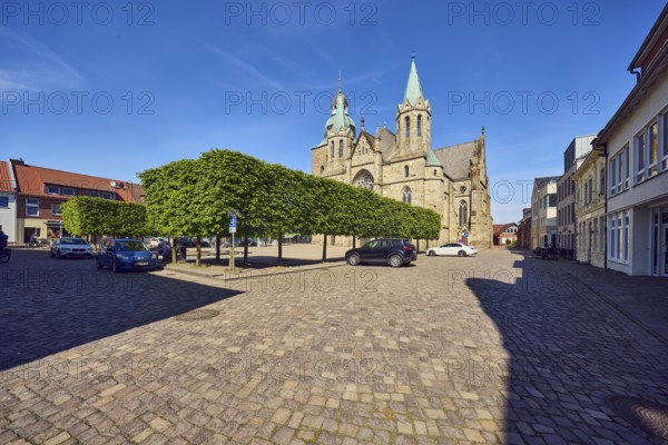 St. Victor church, general architecture, square made of paving stones, parking boxes with cars,