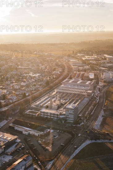 Industrial buildings and roads in a snowy urban landscape at dusk, Althengstett, Calw district,