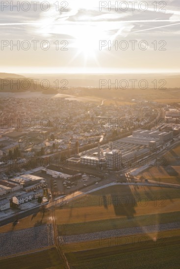 Aerial view of a city at sunset with snow-covered fields and shadow effects, Althengstett, Calw