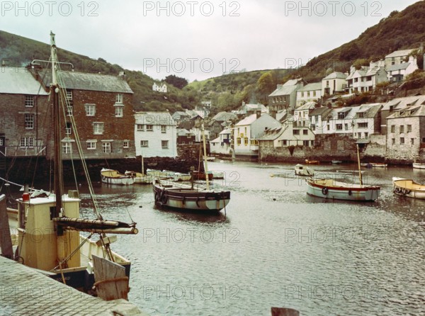 Historic waterfront buildings around the harbour river mouth of the River Pol at village of