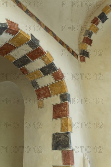 Painted arch in red, yellow and black. St Aignan's Church of Begues. Allier department. Auvergne